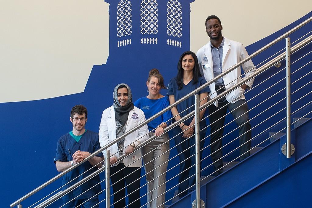 A group of health students standing on the staircase in Innovation Hall