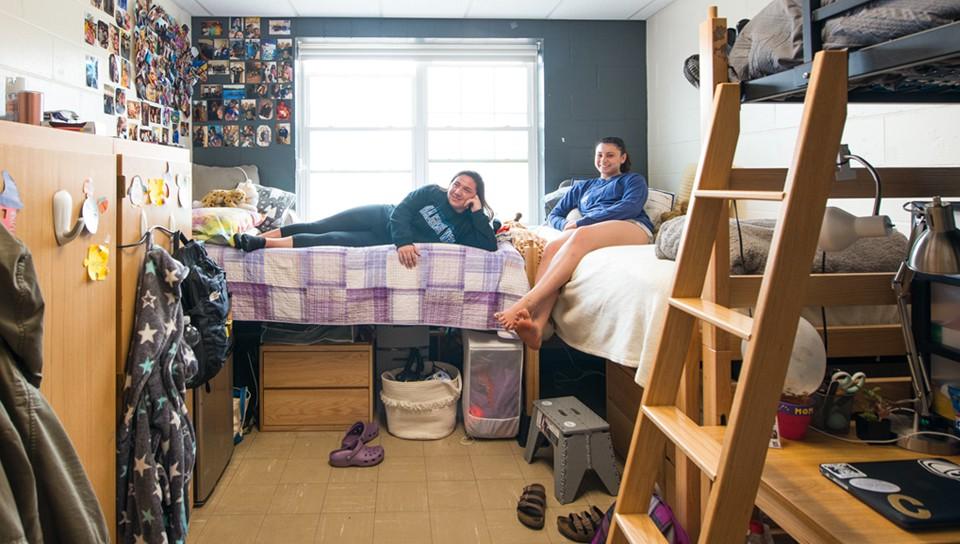 Two students hanging out in their dorm room