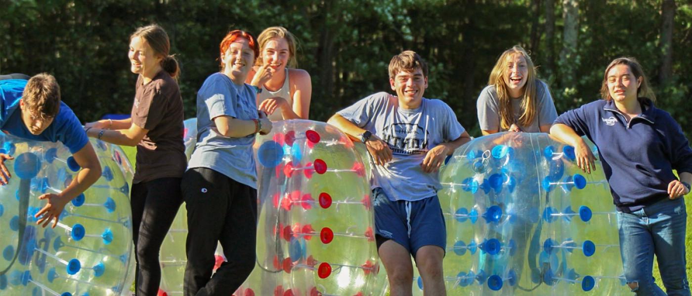 Students lined up to play bubble soccer