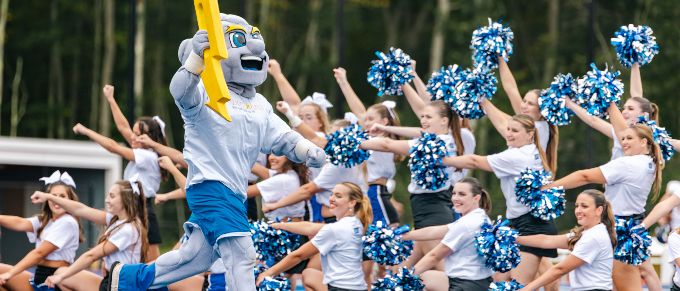 UNE mascot Stormin' Norman high-fives members of the dance team