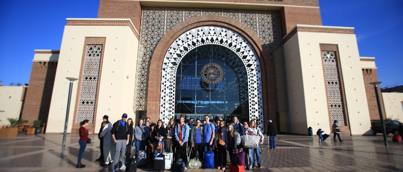 Students arrive at the Marrakesh train station during a group excursion.